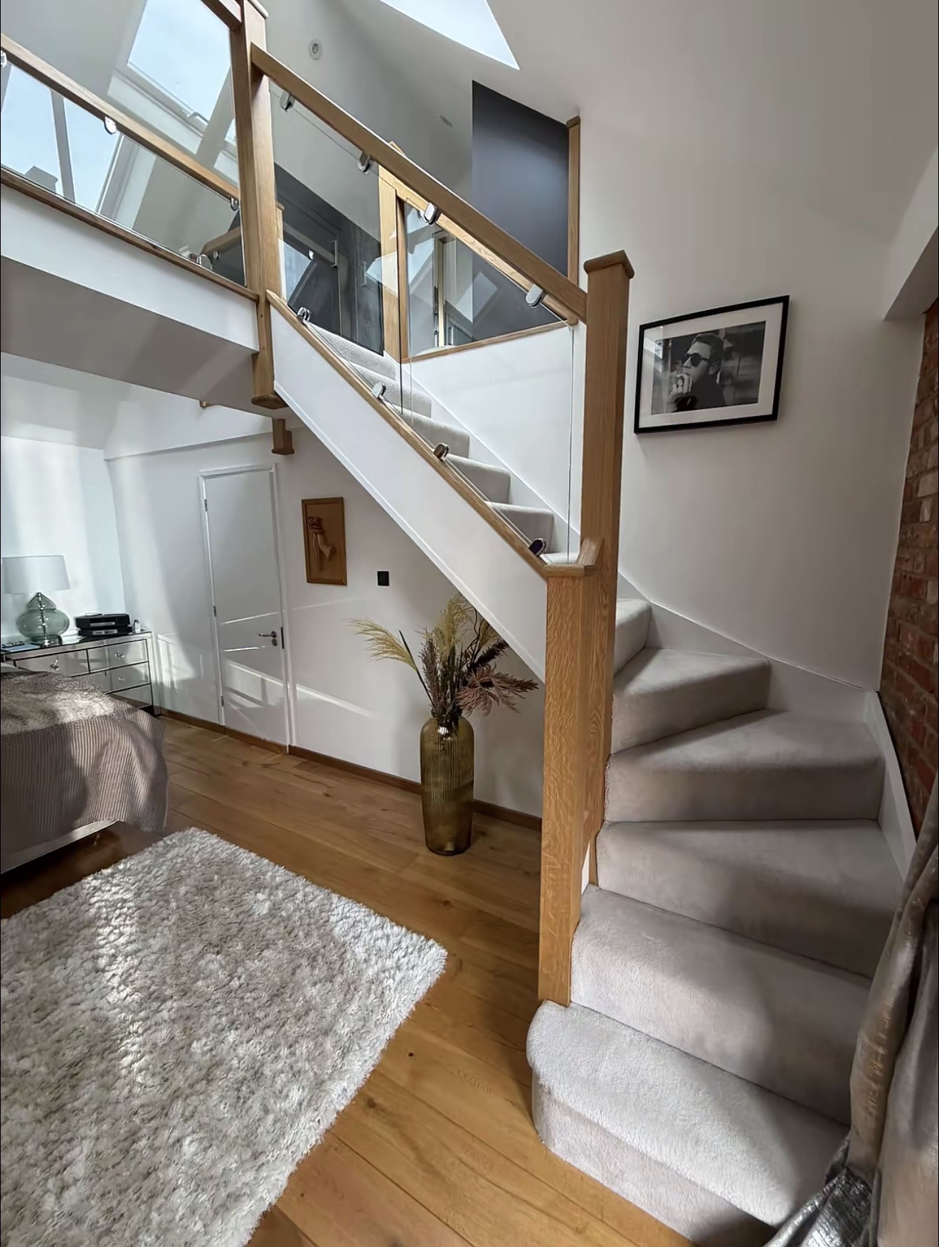 Completed oak staircase with glass balustrade and timber handrails